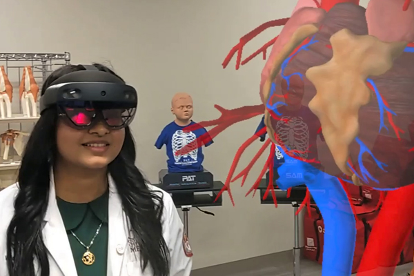 Student with virtual reality googles examining the heart