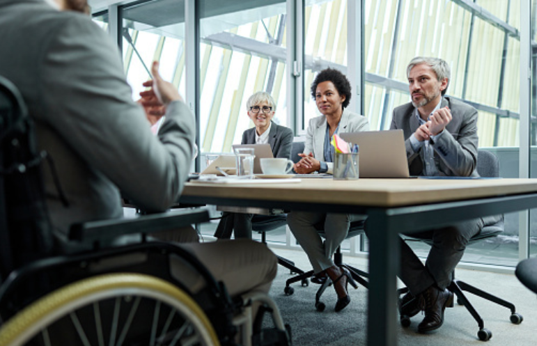 man in a wheelchair interviewing