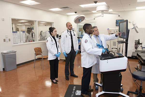 PCOM Georgia students being trained on a robotic simulator