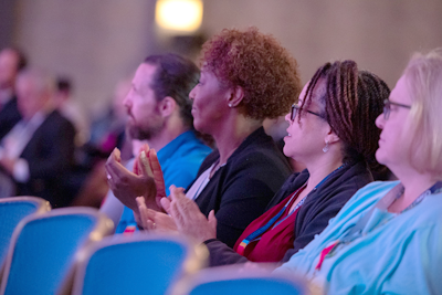 Diverse audience clapping