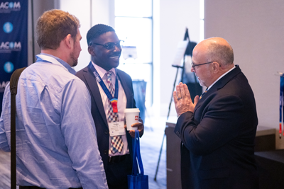 Three men conversing