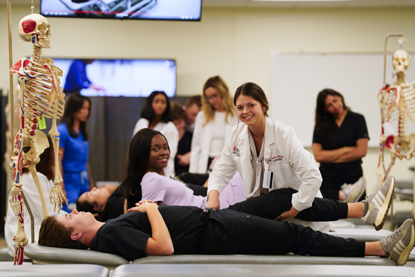 UIWSOM medical students in an anatomy lab practice OMM.