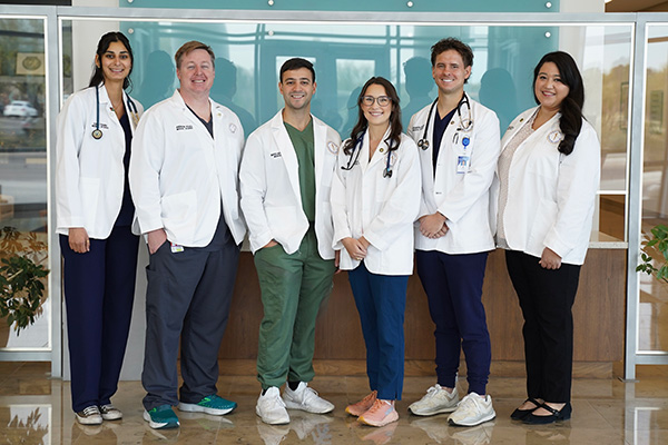 Group photo of BCSOM students in white coats