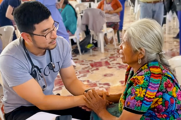 KCU student listens to an elderly female patient during a Global Health program in Guatamala