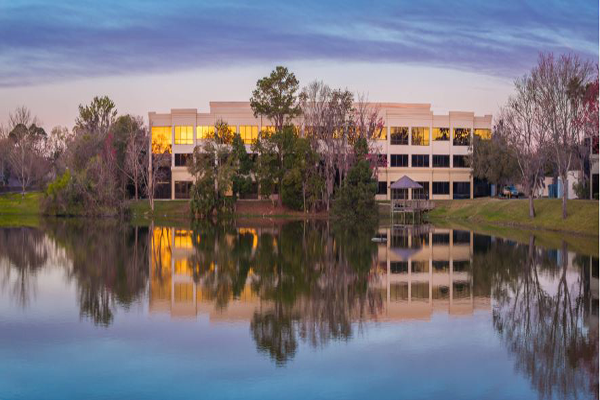 LMU-DCOM Campus bordering a lake in Spring