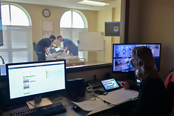 Students practicing on a simulated patient