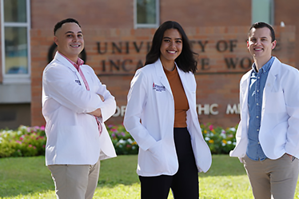 UIWSOM students in front of a campus building