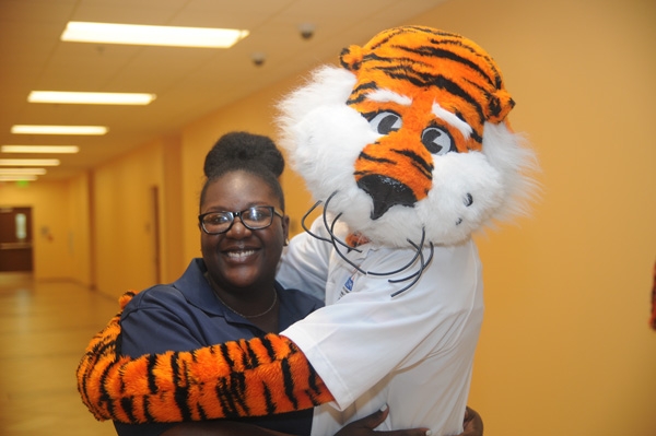 Tiger mascot poses with a female student