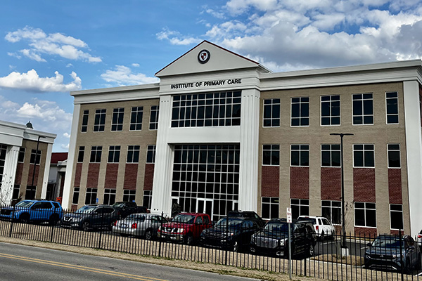 WCUCOM's Institute of Primary Care building on a sunny day.