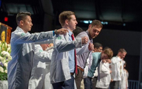New WesternU-COMP students receiving their whitecoats