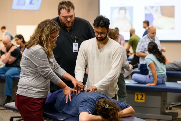 WVSOM students practicing osteopathic manipulation techniques in class.