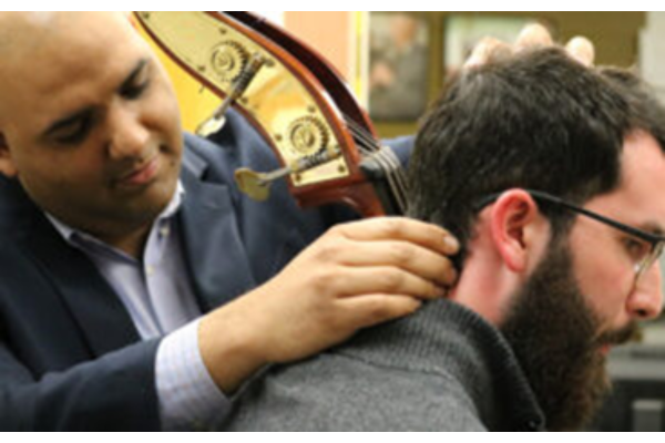 Dr. Surve examining a cellist.