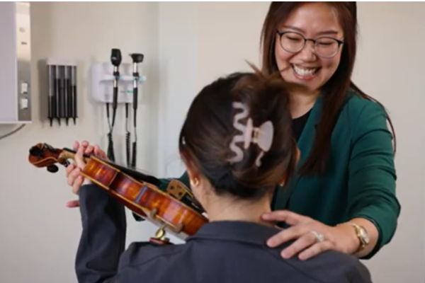 Dr. Lee working with a violinist.