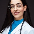 Sharzhadsmilesforaprofessionalphotowearingherwhitecoatandstethoscope
