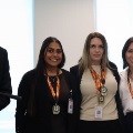 Agroupofmedicalstudentsandafacultymemberposetogetherallwearingbadgesandmedalsataformalevent