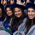 Graduatingmedicalstudentssmileintheiracademicregaliaduringacommencementceremony