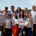 AgroupofICOMmedicalstudentsposeoutdoorsholdingICOMGlobalBrigadessignsduringaninternationalservicetrip