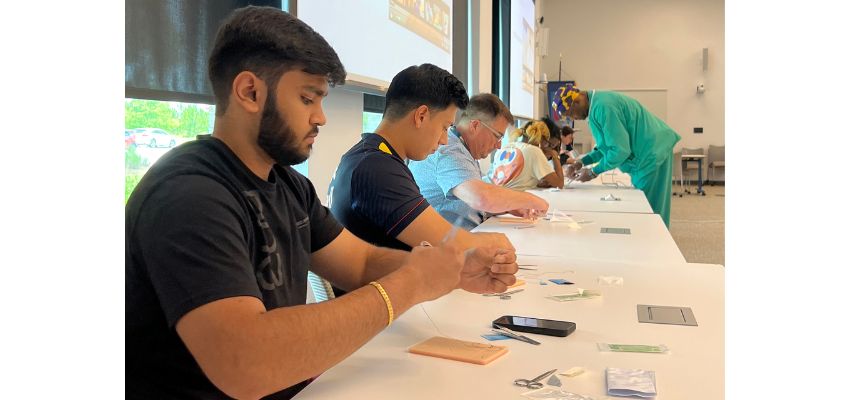 Medical students at PCOM South Georgia participate in a hands-on suturing workshop in a classroom setting.