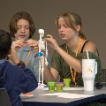 TwostudentsfromVCOM-Auburnarerecognizedwithanawardplaqueduringaceremonywithfacultypresent