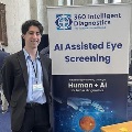 AstudentstandsnexttoadisplayboothpromotingAI-assistedeyescreeningatahealthcareortechnologyevent
