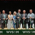 AgroupofleadersandfacultystandonstageholdinggoldshovelsataWVSOMgroundbreakingceremony