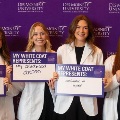 SixmedicalstudentsinwhitecoatsstandinfrontofaDesMoinesUniversitybackdropeachholdingsignssharingwhattheirwhitecoatrepresents