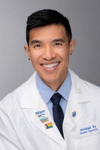 Michael Ny smiles in a whitecoat