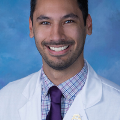 Philipsmilesforaprofessionalheadshotwearinghiswhitecoat