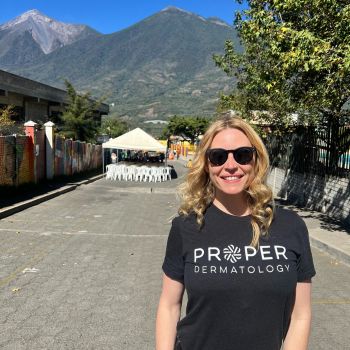 Dr. Reed smiles outside on a sunny day with mountains in the background
