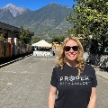 DrReedsmilesoutsideonasunnydaywithmountainsinthebackground