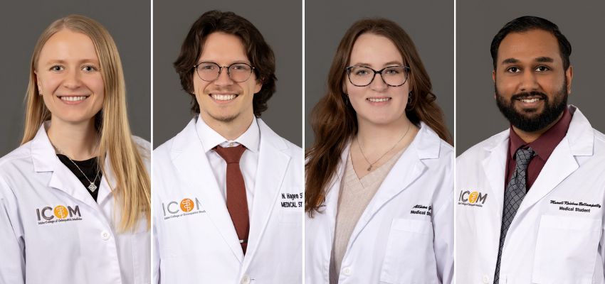 Four ICOM students wearing their white coats smile for professional headshots