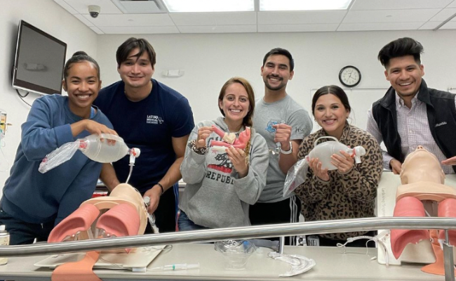 Students smiling while practicing intubation