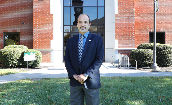 Doctor stands in front of WVSOM entrance