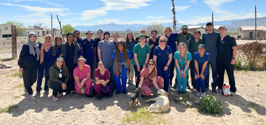 Students pose for photo in front of mountain backdrop