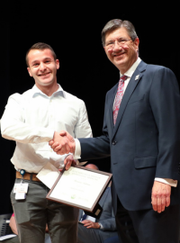 WVSOM dean shakes hand of student