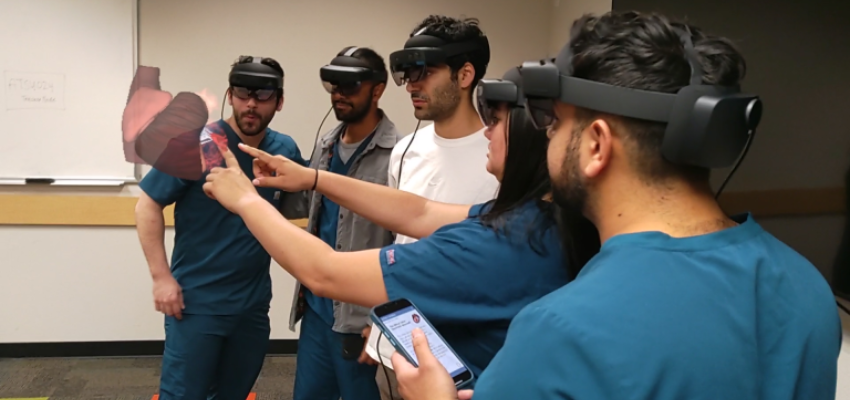Students wearing augmented reality glasses
