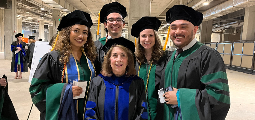 Students pose in caps and gowns