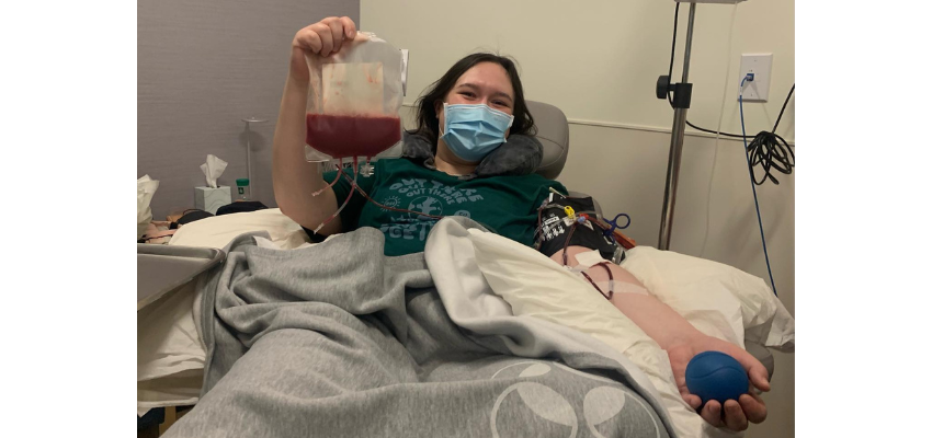 Madison in a hospital bed holding stem sell donation.