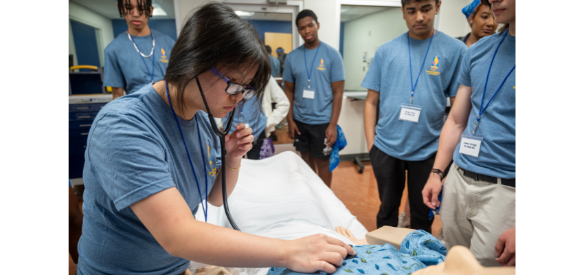 High school student uses stethoscope to listen to heartbeat