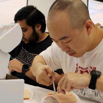 Medical student practices suturing