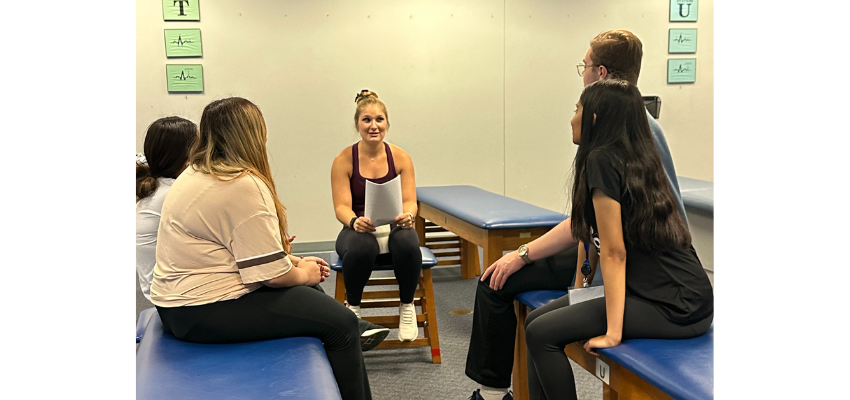 Medical student shows high-schoolers around OMM lab