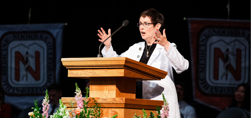 Dr. Nichols delivers speech from wooden podium