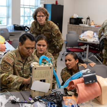 Members of the U.S. military test breathing of a medical mannequin