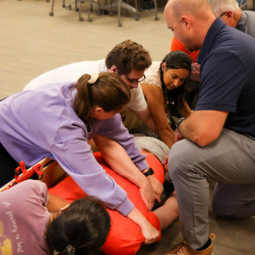 Students stabilize actor on a stretcher