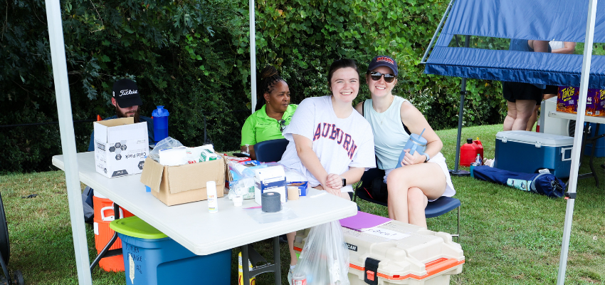 VCOM-Auburn students staff tent next to the soccer field