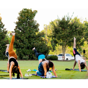 Students do yoga while outside