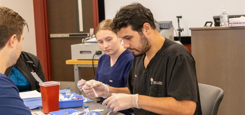 Students prepare instruments for medical use in the simulation lab