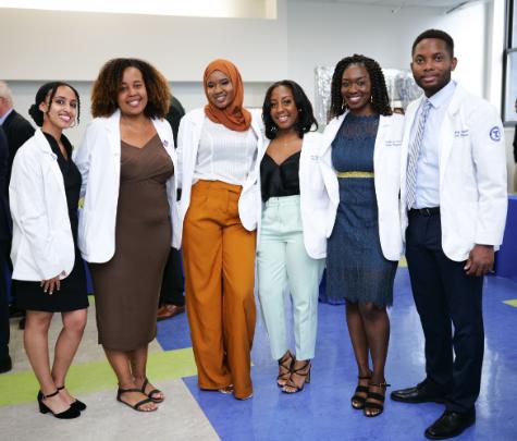 A diverse group of medical students standing in a classroom