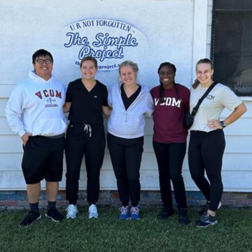 Five students standing in front of the Simple Project headquarters