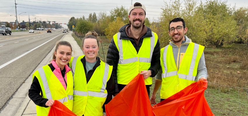Four medical students with trashbags next to the highway